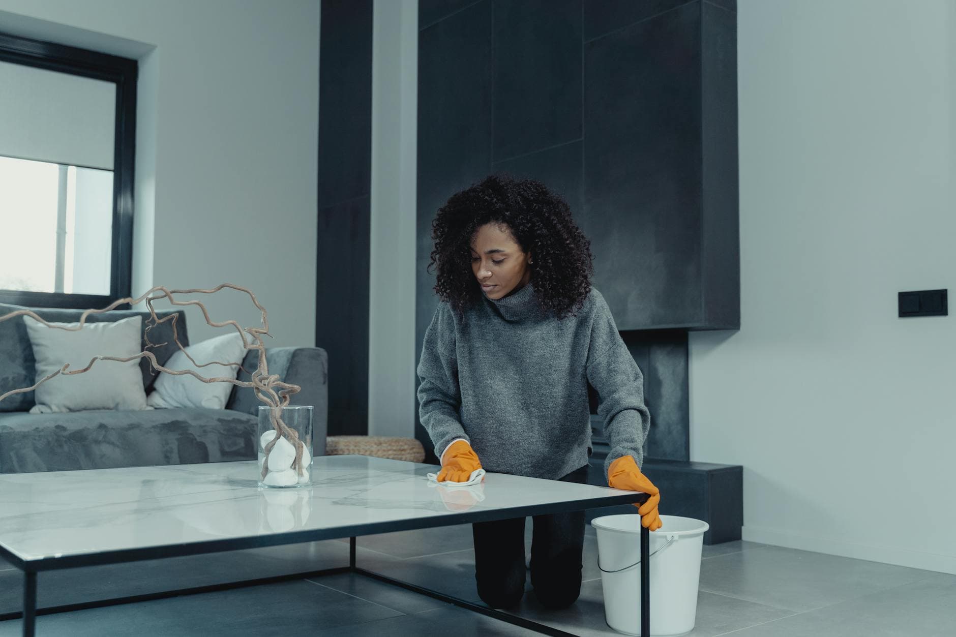 Professional house cleaner wiping a table in a contemporary apartment — cleaning services in Old City, Philadelphia