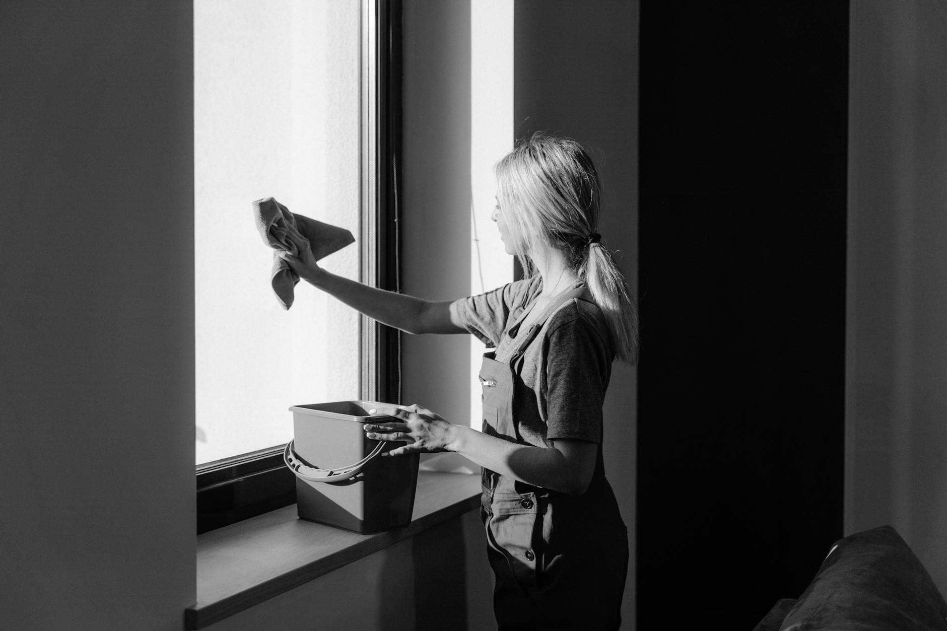 Professional window cleaning in a Pennsylvania apartment using cloth and bucket — cleaning services in Fishtown, Philadelphia